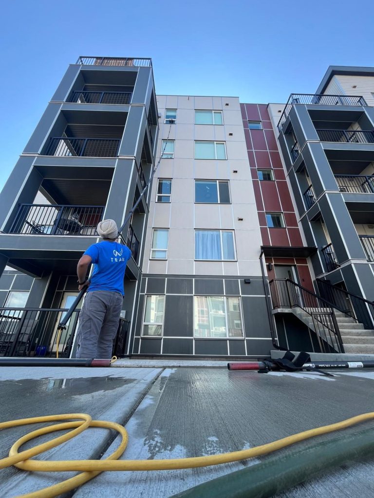 Cleaning Angels team member cleaning the exterior windows of a Kelowna strata building